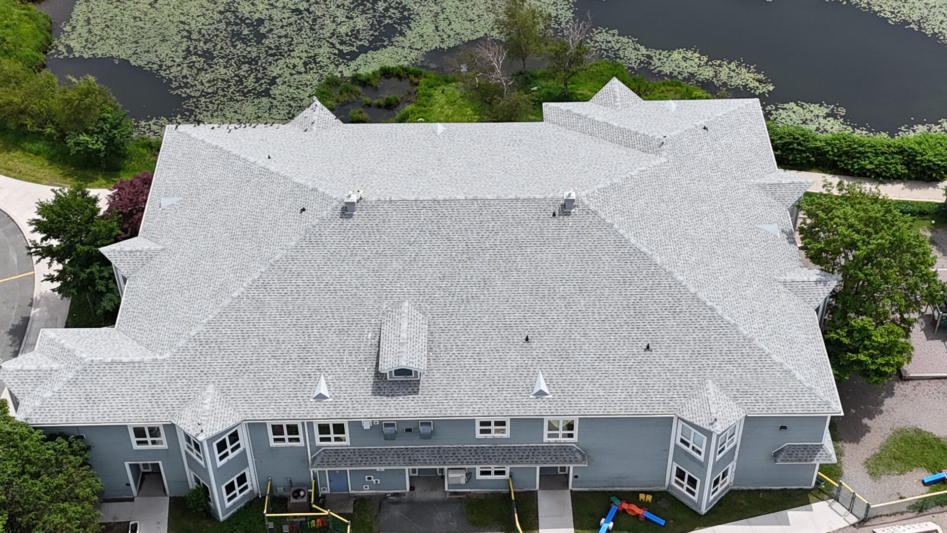 Overhead perspective of a substantial building featuring a prominent roof structure