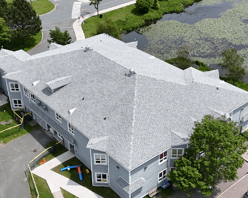 Overhead perspective of a substantial building featuring a prominent roof structure