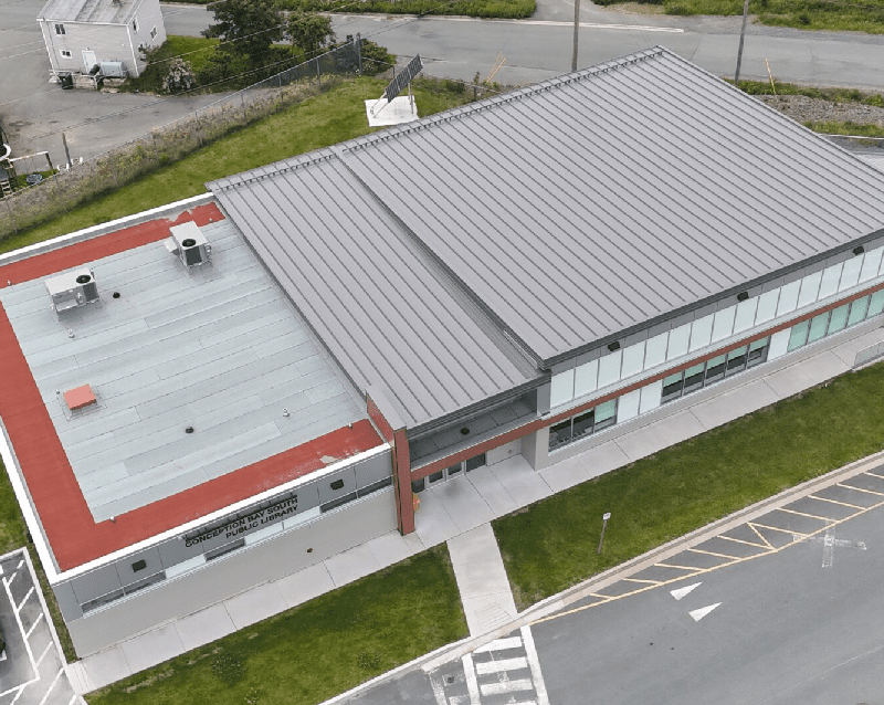 The building has a unique design, with a metal roof and a red tiled roof