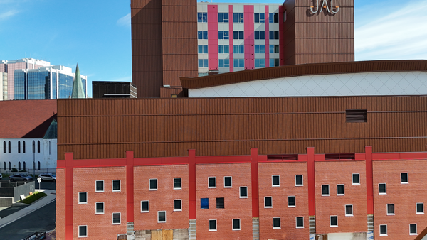 Construction site with insulated building wall under a clear sky